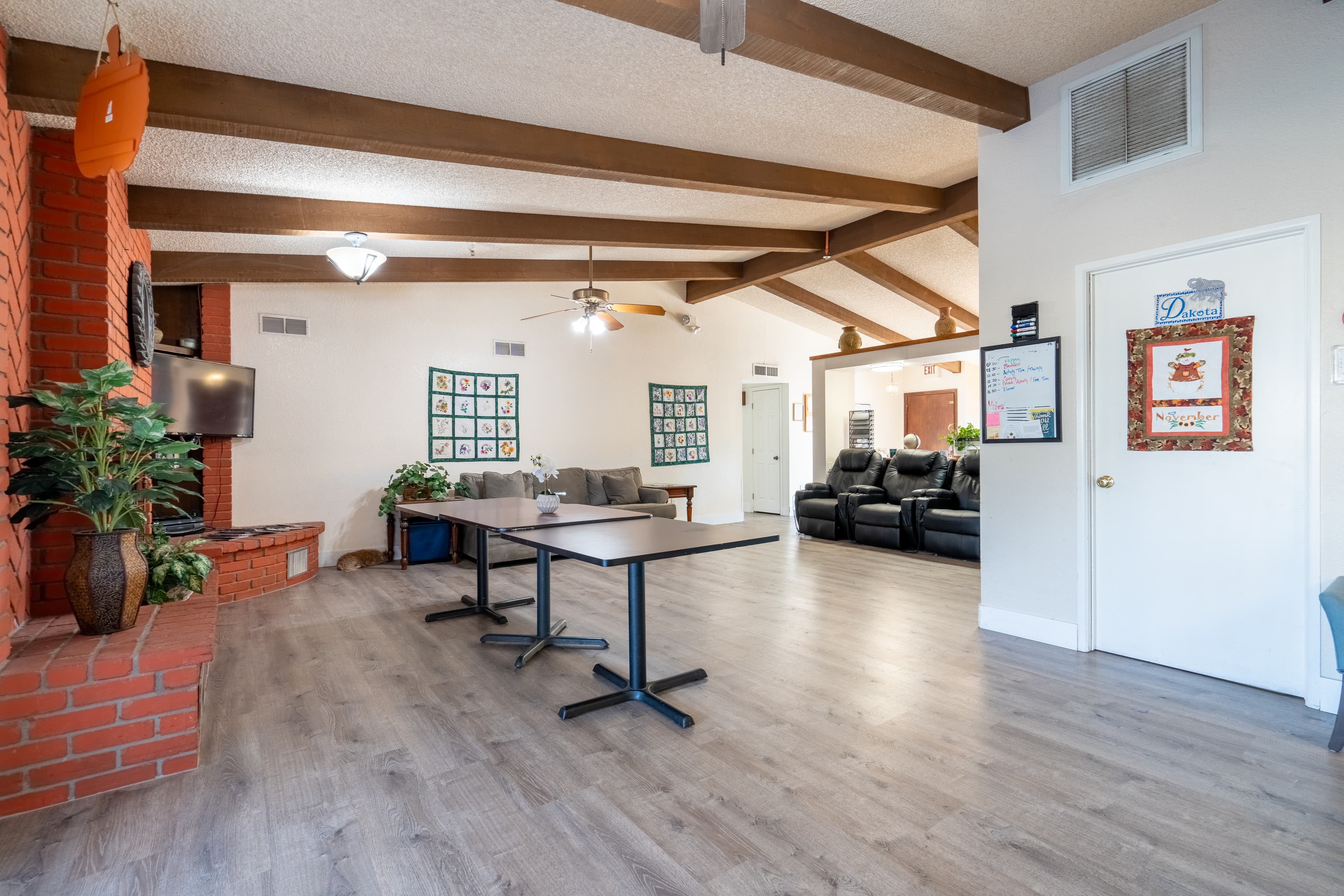 Warm common room with brick fireplace and comfortable seating